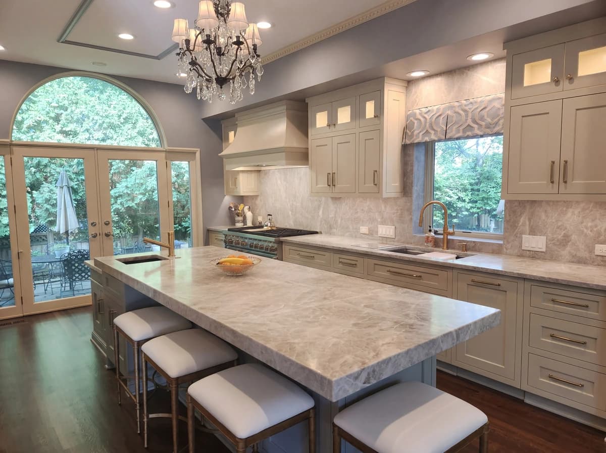 Elegant kitchen with marble countertops, island, and cabinets.